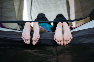 Low section of kids lying on tent