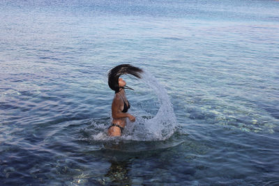 Full length of woman swimming in sea