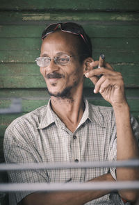 Portrait of young man with eyeglasses standing outdoors