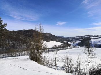 Scenic view of snow covered mountains against sky