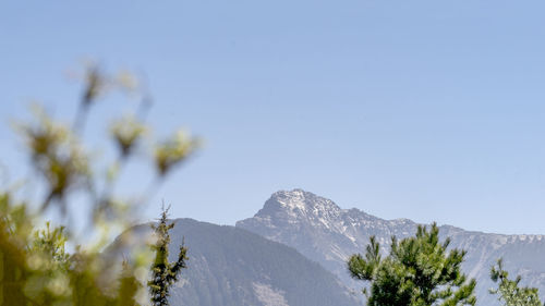 Scenic view of snowcapped mountains against clear sky