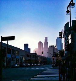 View of city street against blue sky