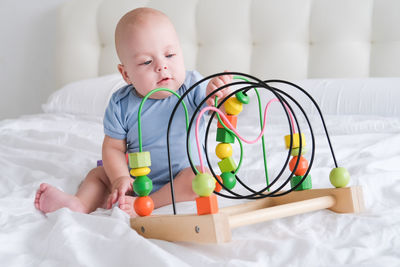 Portrait of cute baby boy playing with toy blocks