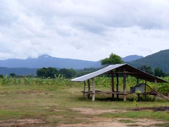 Scenic view of mountains against cloudy sky