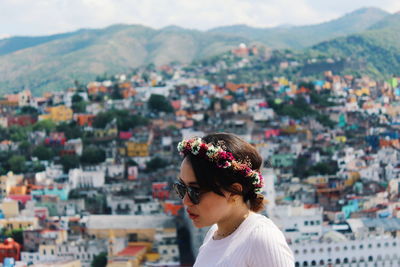 Portrait of young woman looking at cityscape