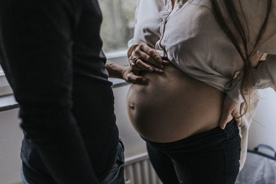 Pregnant woman with partner standing together
