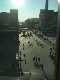 High angle view of people on street amidst buildings in city