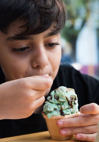 Close-up portrait of boy eating food