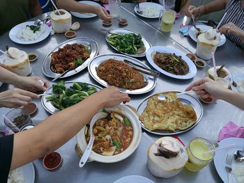 High angle view of people having meal served on table at home