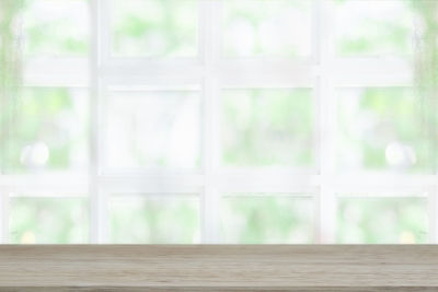 Close-up of glass window on wooden floor