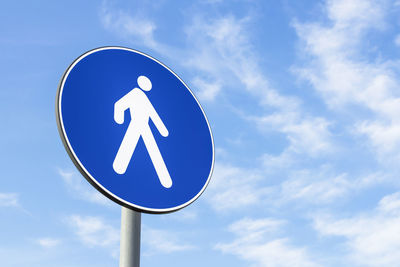 Low angle view of road sign against sky