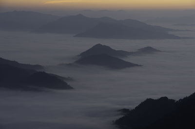 Scenic view of silhouette mountains against sky during sunset