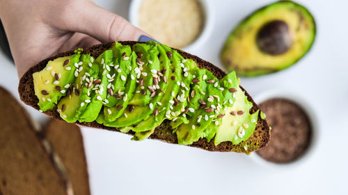 Ingredients for healthy avocado toast. ripe hass avocado, wholegrain bread, sesame 