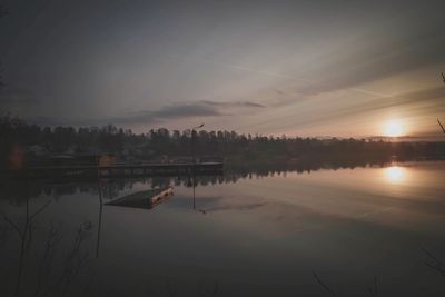 Scenic view of lake against sky at sunset