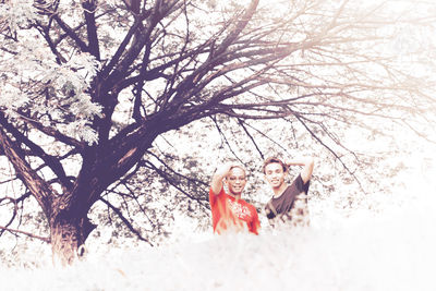 Close-up of happy girl on tree