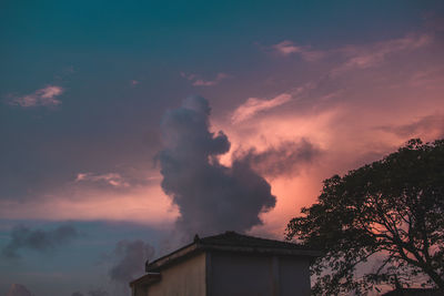 Low angle view of building against sky at sunset