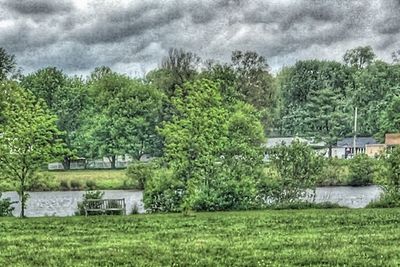 Scenic view of grassy field against cloudy sky