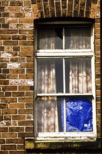 Close-up of window on brick wall