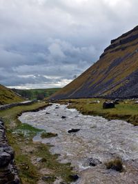 Scenic view of swollen stream heading away from gordale scar, yorkshire dales