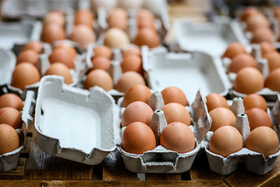 Close-up of egg cartons on table in market