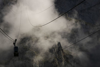 Landscape showing a cable car among the fog and a mountain in fuente de in spanish picos de europa 