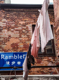 Low angle view of clothes drying against building