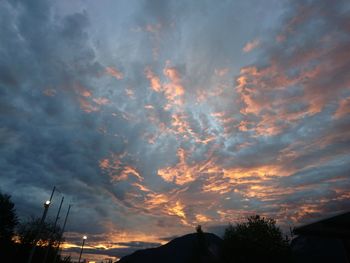 Low angle view of silhouette trees against sky at sunset