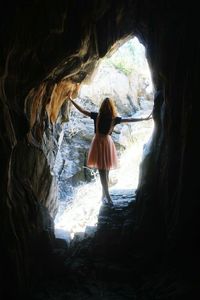 Rear view of woman walking in corridor