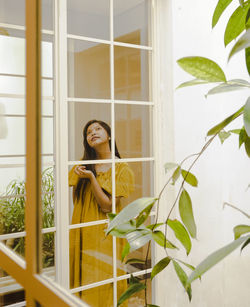 Woman standing by window