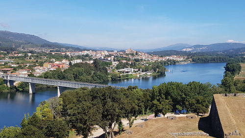 Scenic view of river by trees against sky