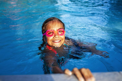 Portrait of young woman swimming in lake