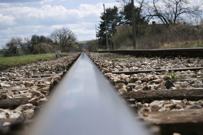 Surface level of railroad tracks against sky