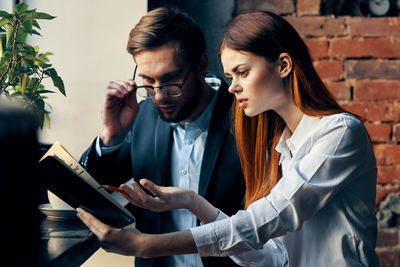 Male and female entrepreneurs discussing at office