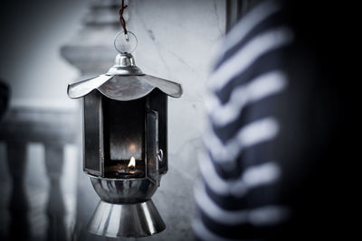 Close-up of oil lamp hanging at temple