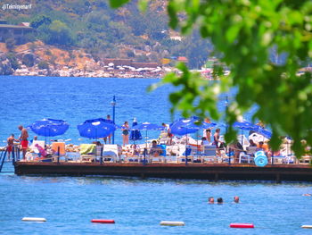 Boats moored in sea against buildings