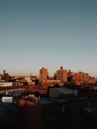 Buildings in city against clear sky