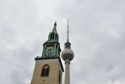 Low angle view of cathedral and fernsehturm against sky