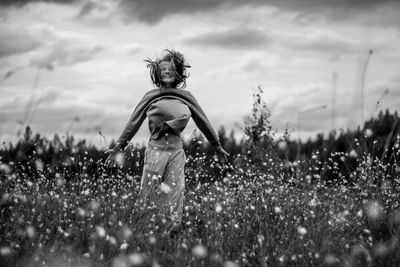 Man standing on field against sky