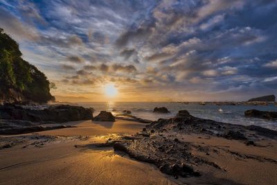 View of beach against cloudy sky