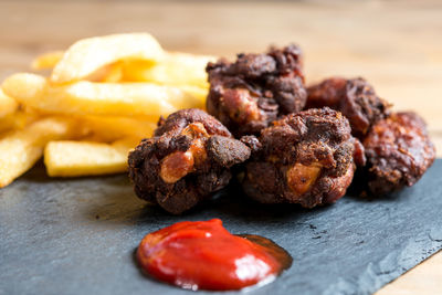 Close-up of fried chicken and french fries with ketchup on table