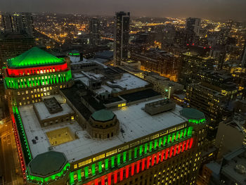 High angle view of illuminated buildings in city at night