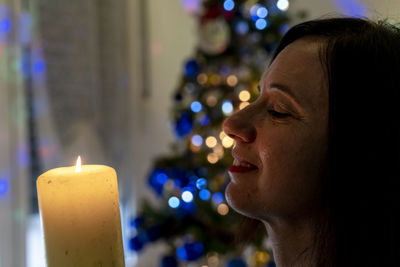 Close-up of young woman blowing birthday candle