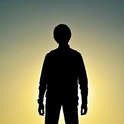 Silhouette man standing against sky during sunset