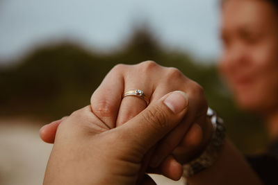 Couple holding hands at beach