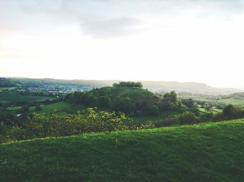 Scenic view of field against cloudy sky