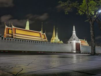 Illuminated temple against sky at night