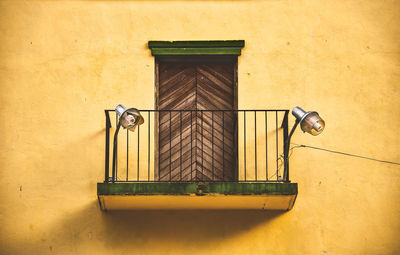 Low angle view of yellow window on building