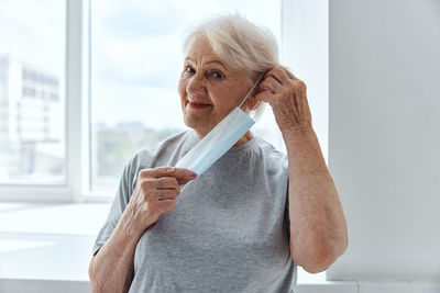 Portrait of smiling senior woman wearing mask