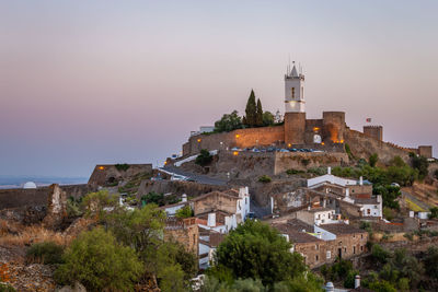 Old town by buildings in city against sky