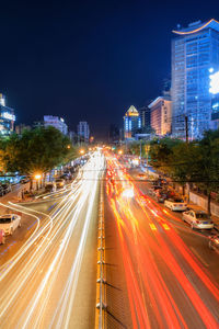 High angle view of light trails on road at night